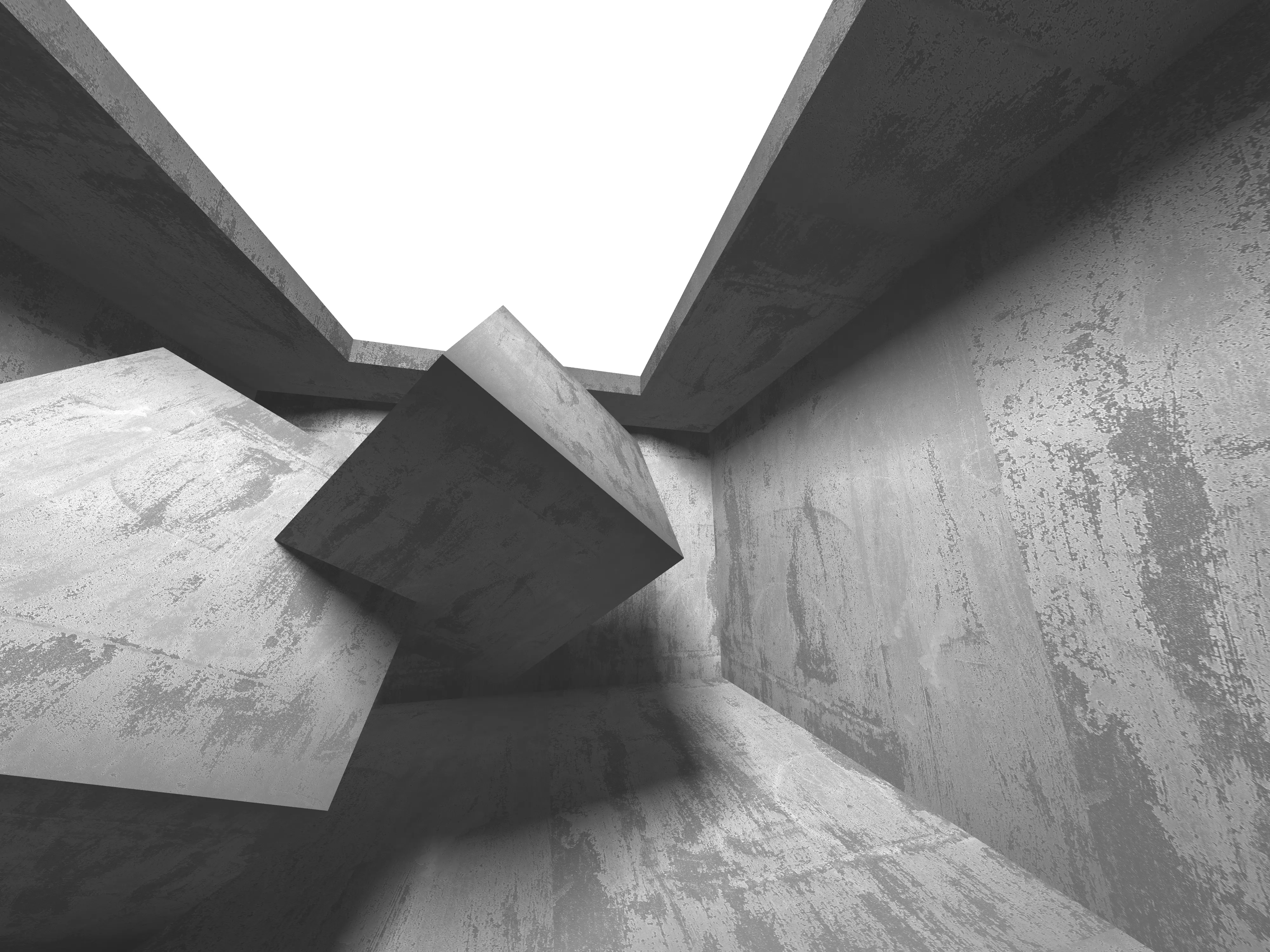Kantige Betonwürfel in offenem Raum mit Licht von oben.