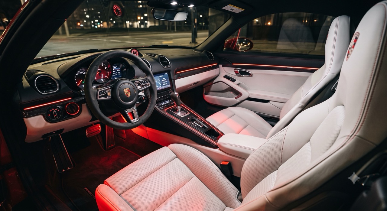 rote Ambientebeleuchtung in einem Porsche Boxter mit weißen Ledersitzen