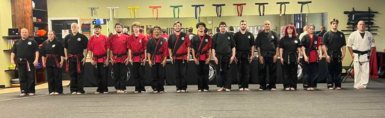 Victory black belts come together for a group photograph.