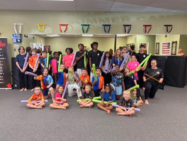 Campers gather for a photograph with their pool noodles.