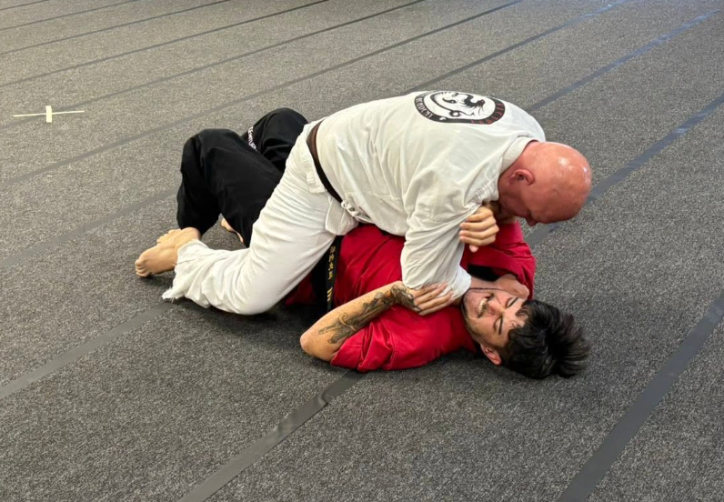 Adult students practice grappling and ground control techniques.