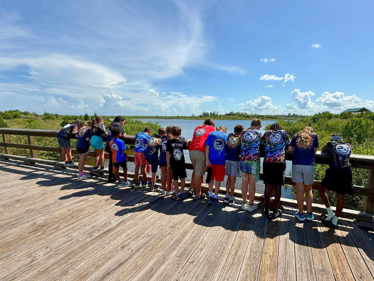 Summer campers pause together to take in the waterfront view.