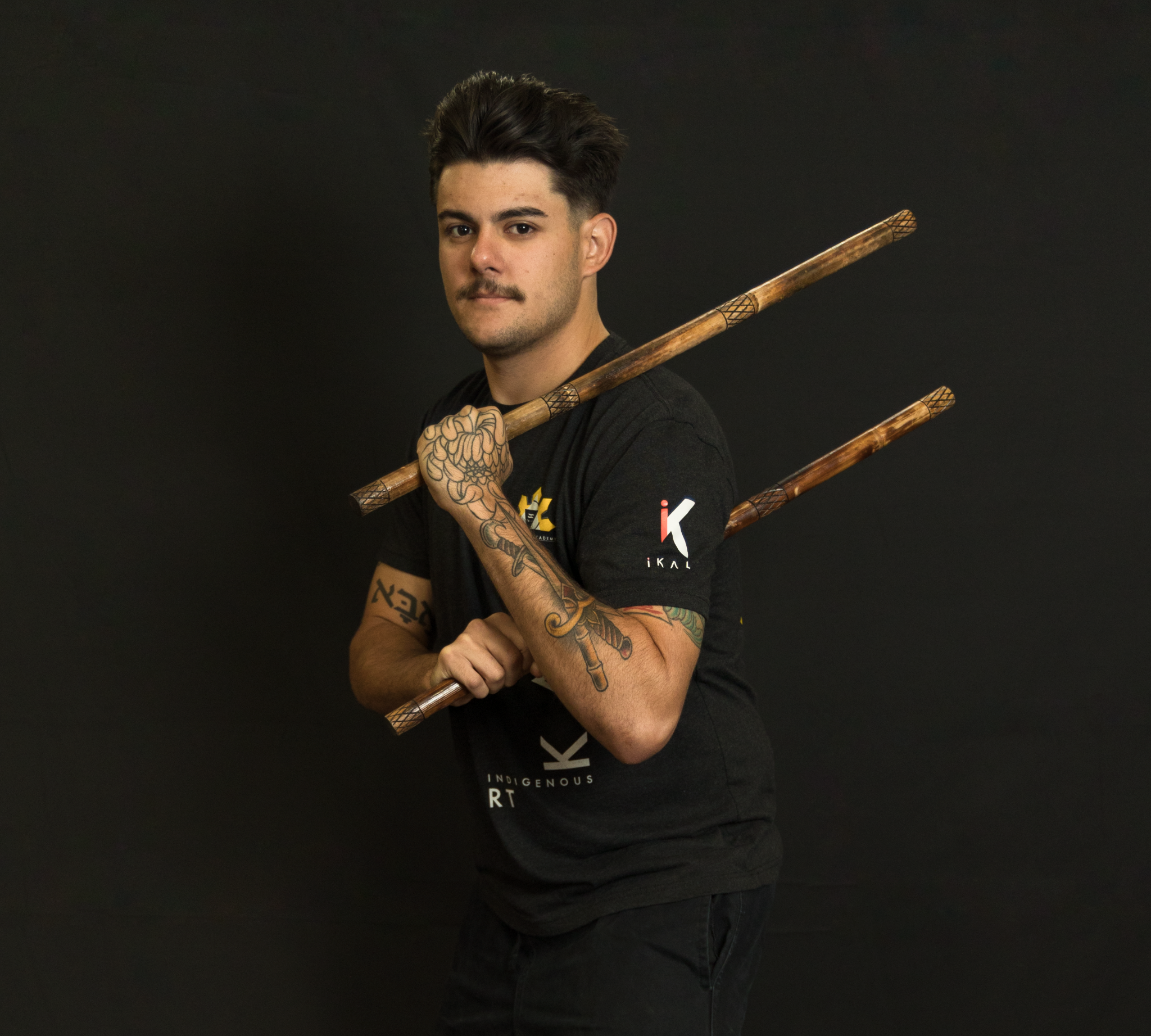 Sensei Brad poses with Kali training sticks.