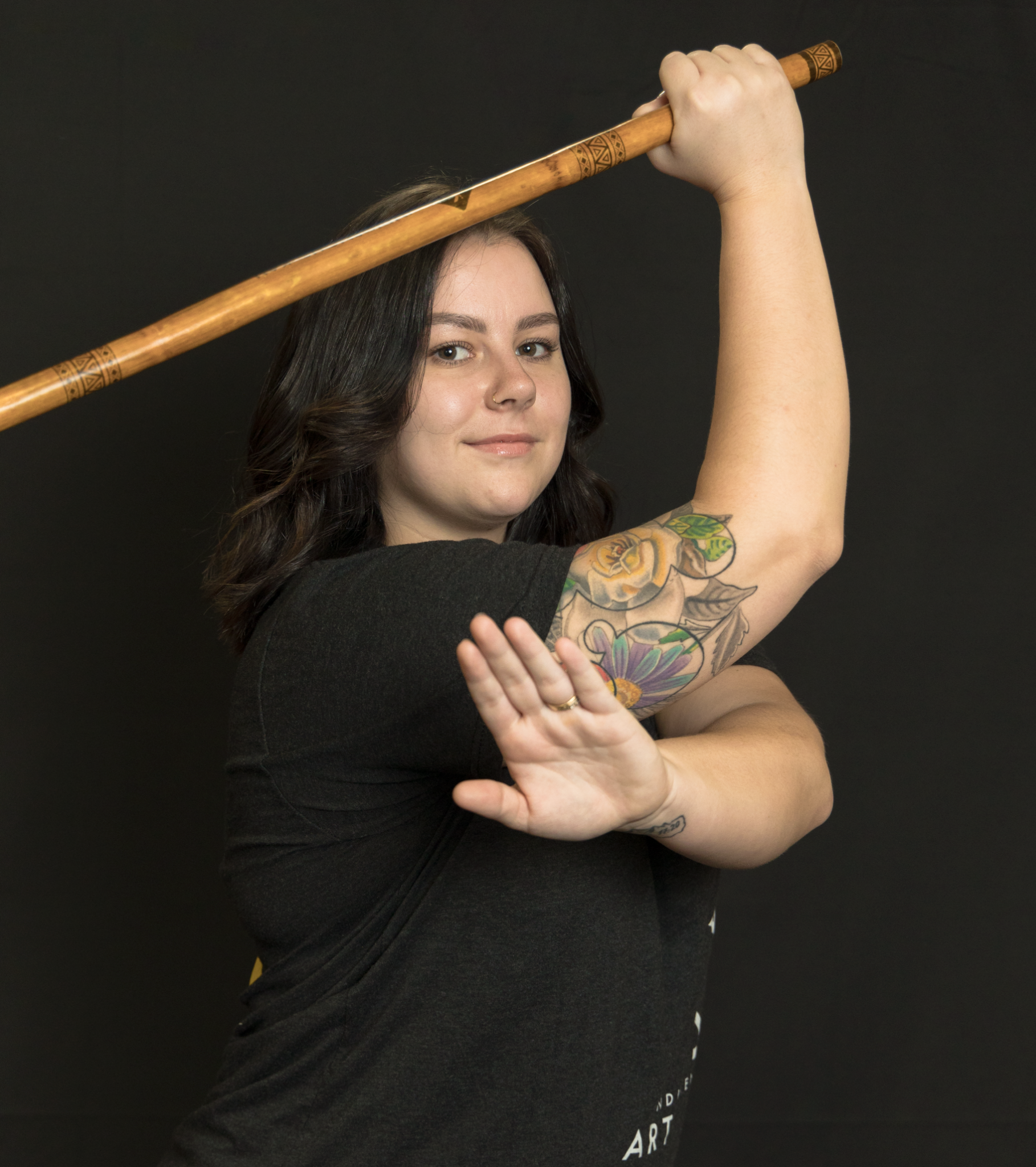 Crissy demonstrates a stance with a Kali training stick.