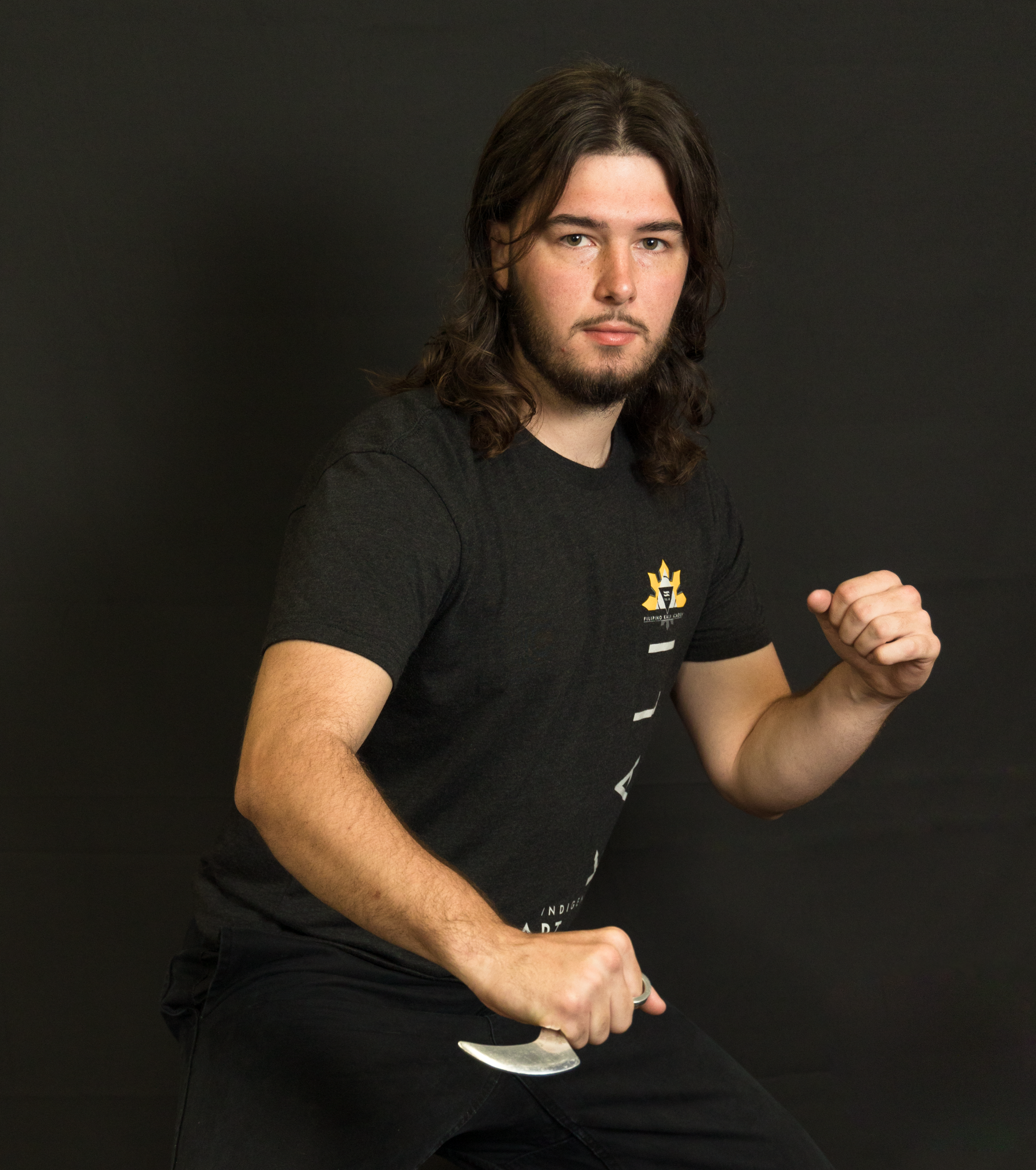 Sensei Cory demonstrates a stance with a curved blade.