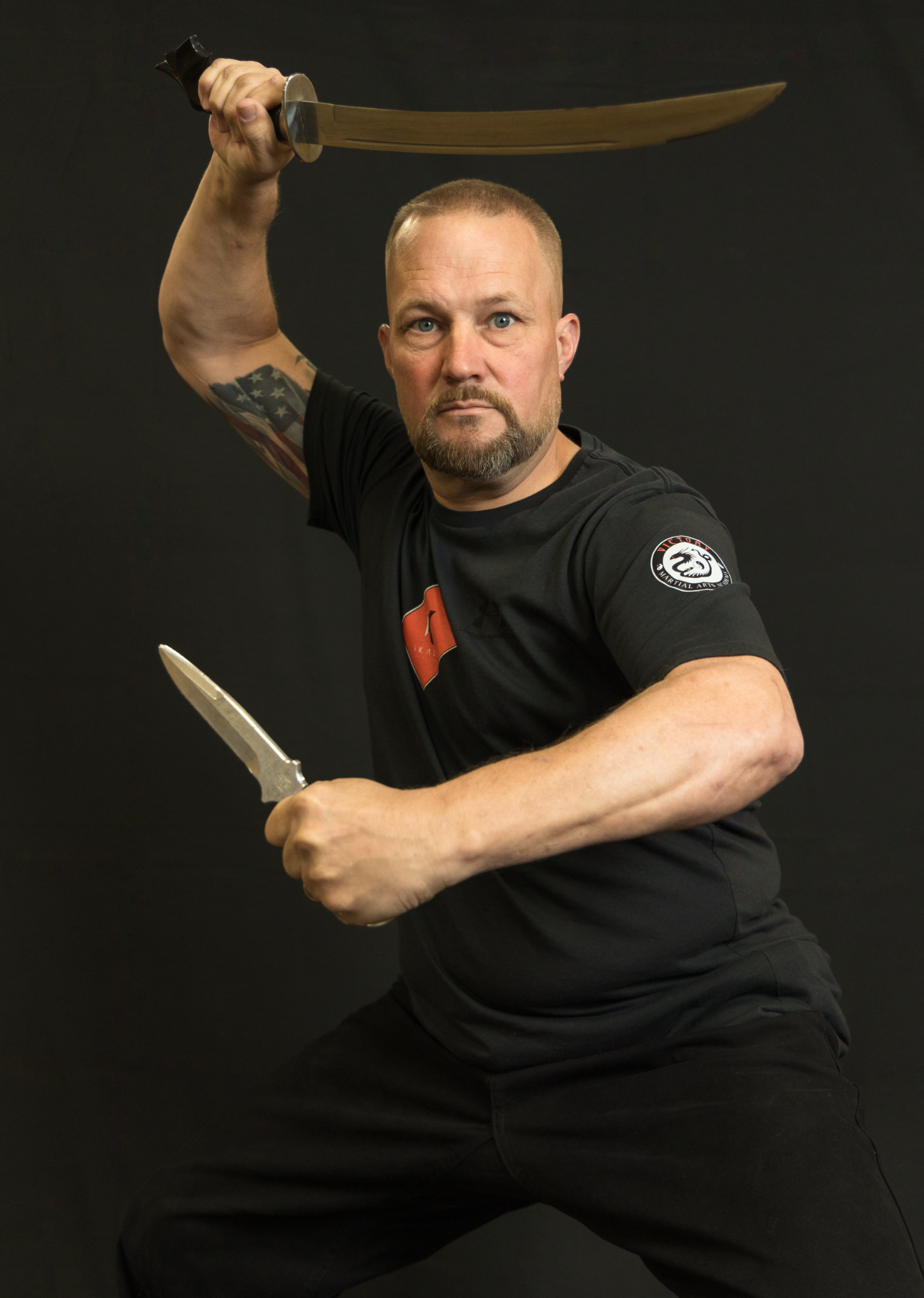 Kyoshi Phil poses with a sword and knife.