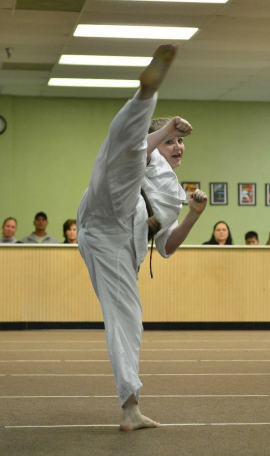 A martial artist demonstrates a high kick.