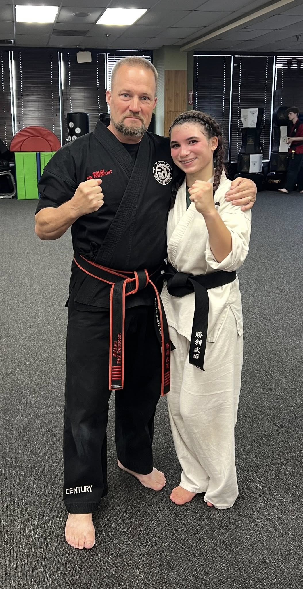 Kyoshi Phil celebrates a student’s black belt achievement.