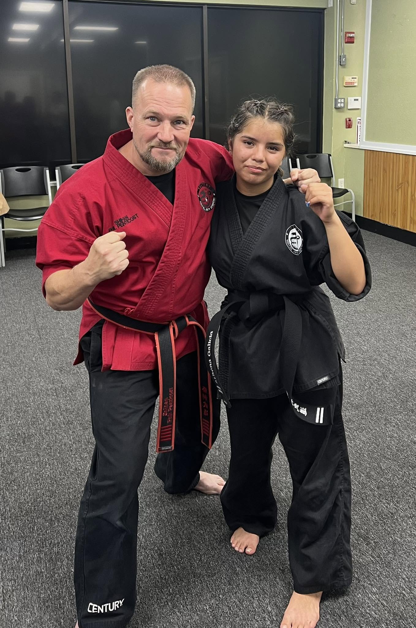 Kyoshi Phil shares a proud moment with a black belt student.