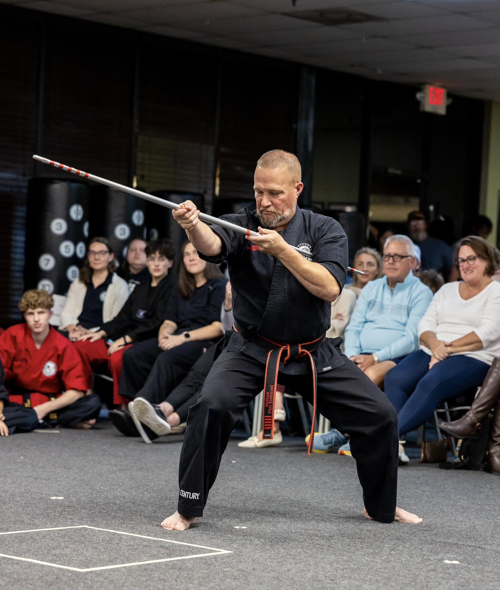 Kyoshi Phil demonstrates bo staff techniques during testing.