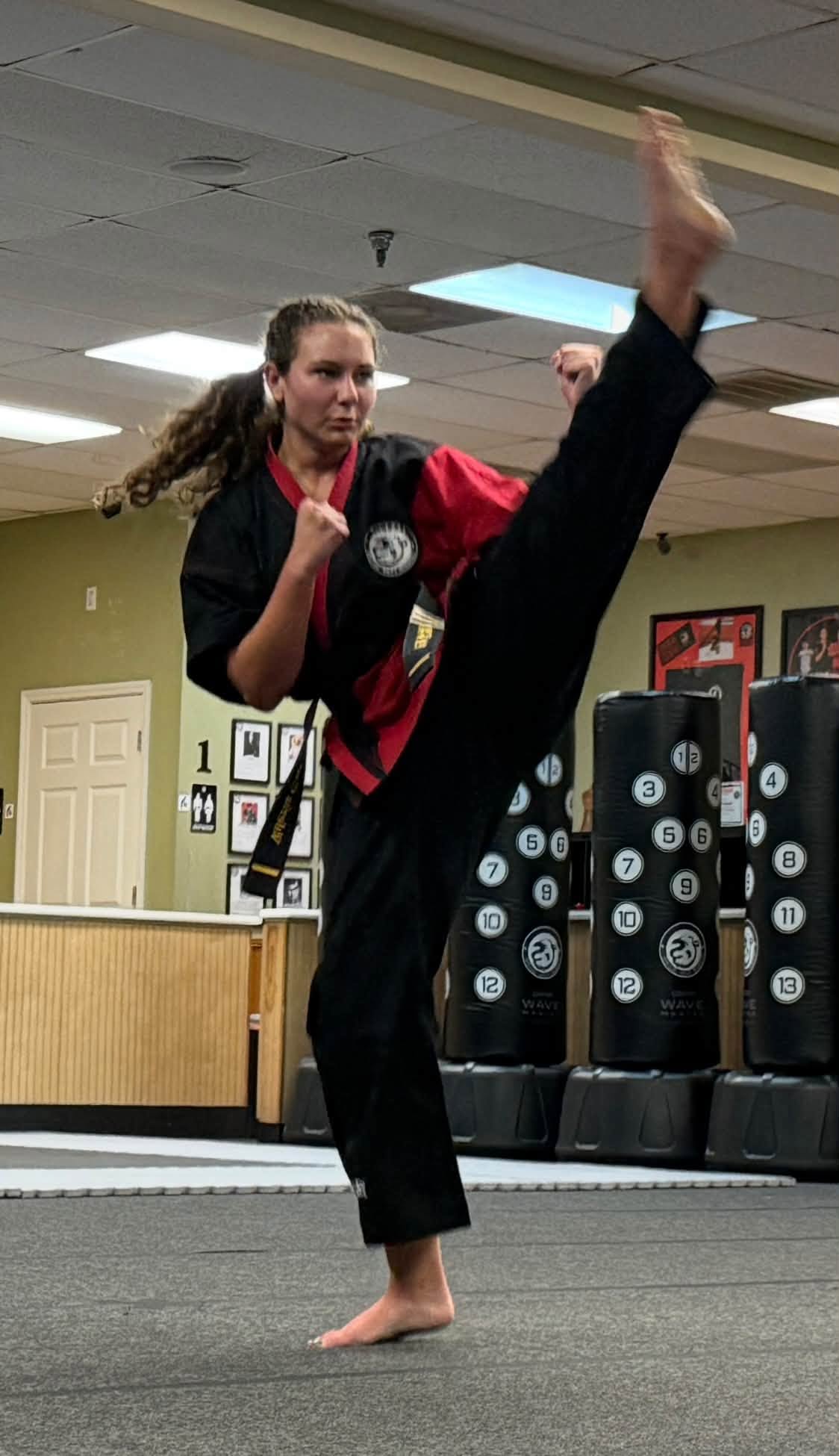 A martial artist demonstrates kicking technique.