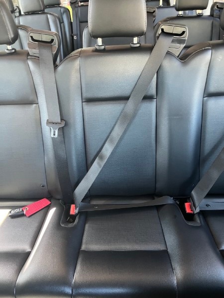 Passenger seating and shoulder seat belts inside a Victory school pickup van