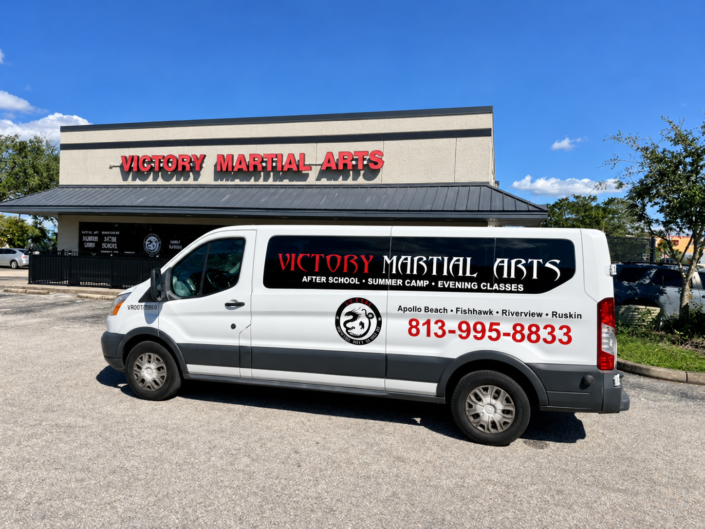 White Victory Martial Arts Academy school pickup van outside the academy