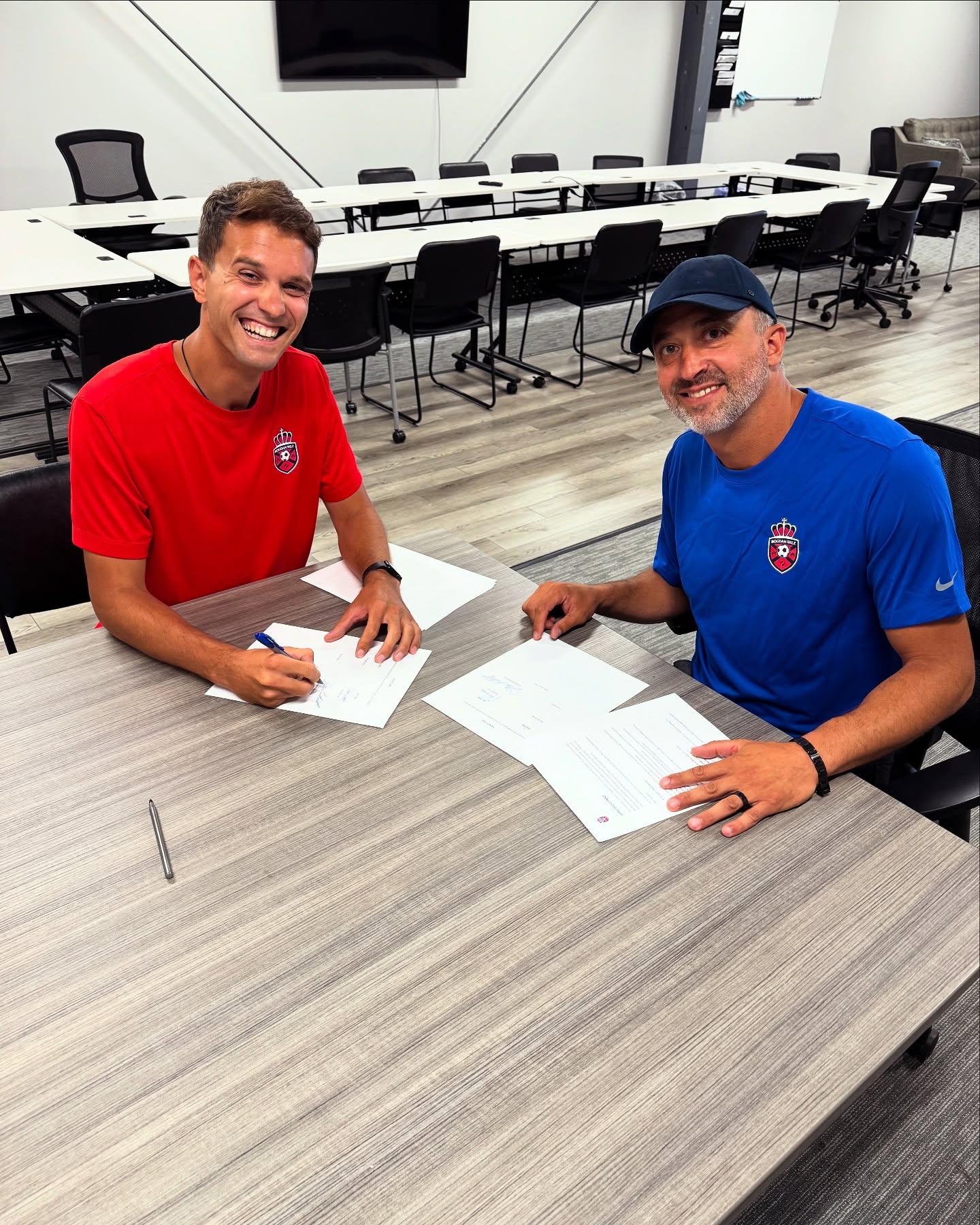 Bogdan Milovanovic and Rich Burritt signing their partnership agreement