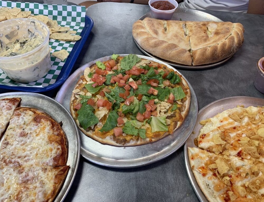 4 slices of Crab Rangoon pizza on a silver platter.