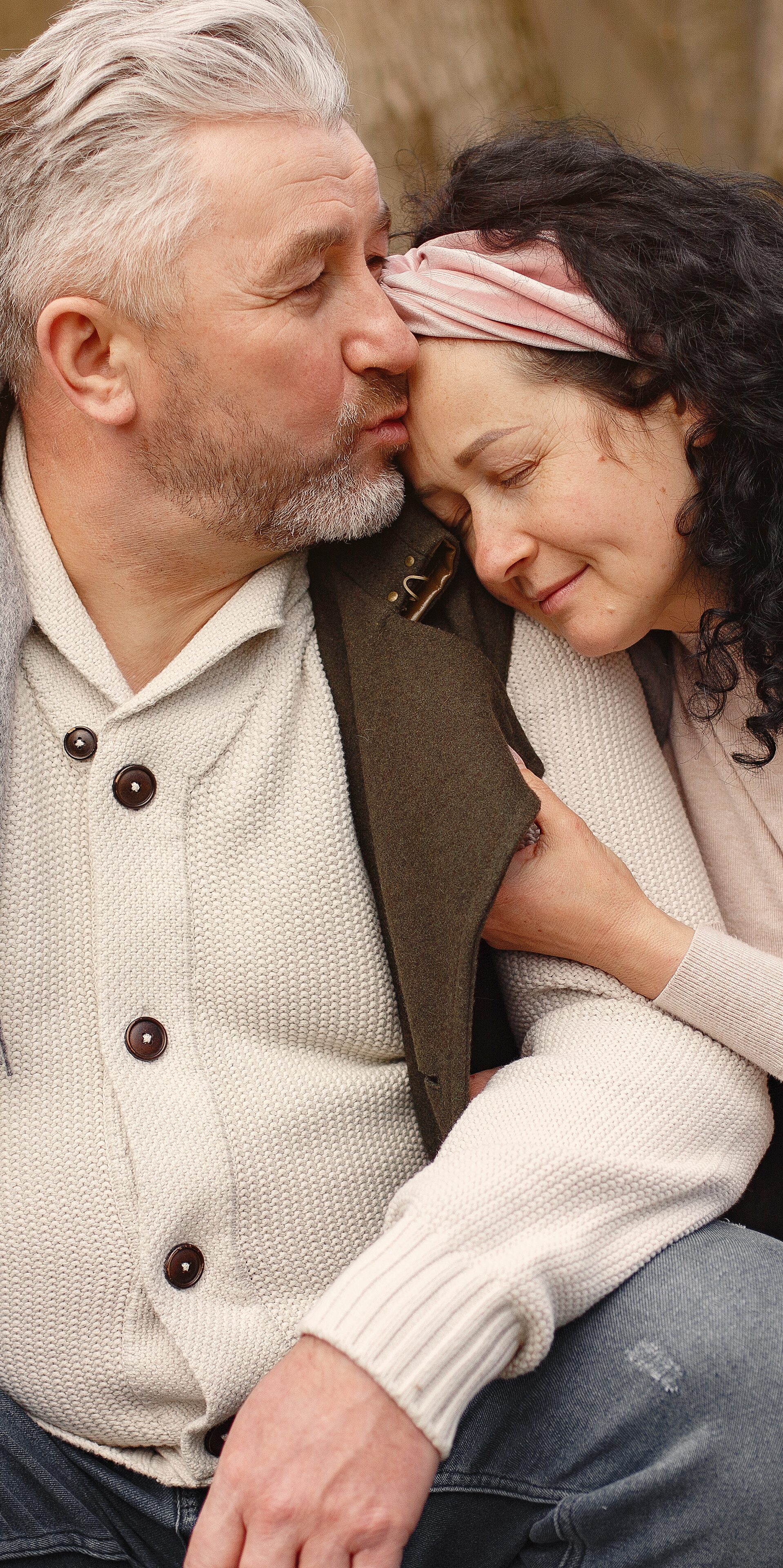 Man kissing woman on forehead, smiling