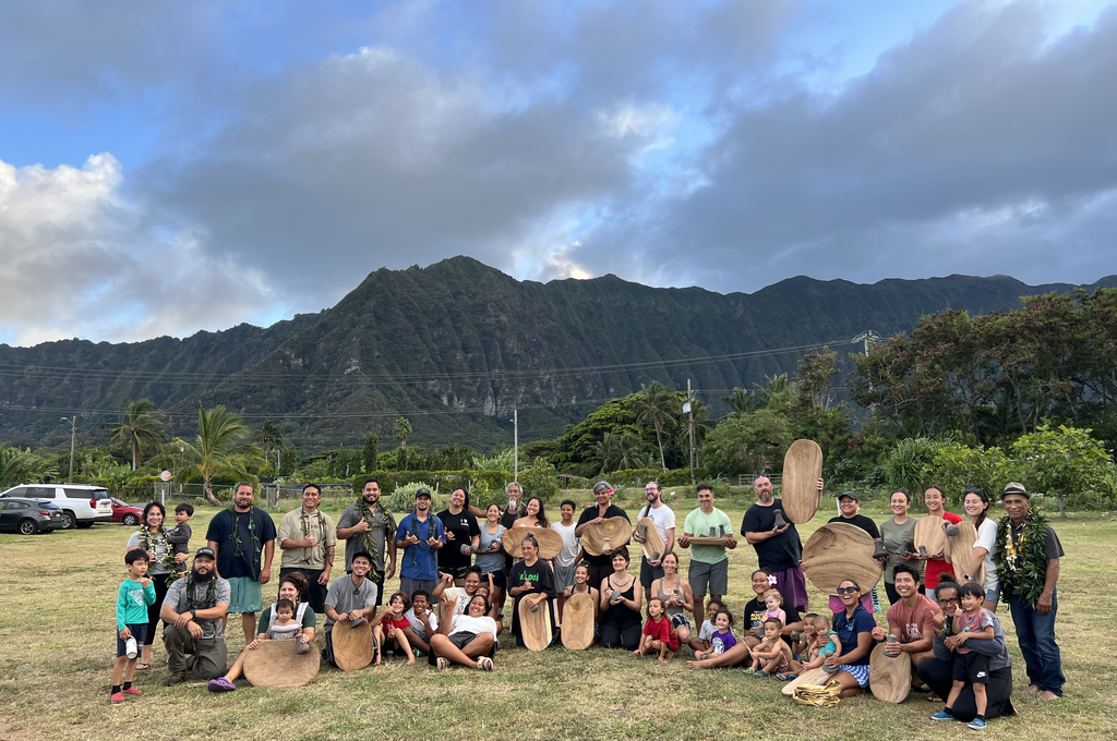 family pounding kalo with the board and stone class at HMKF