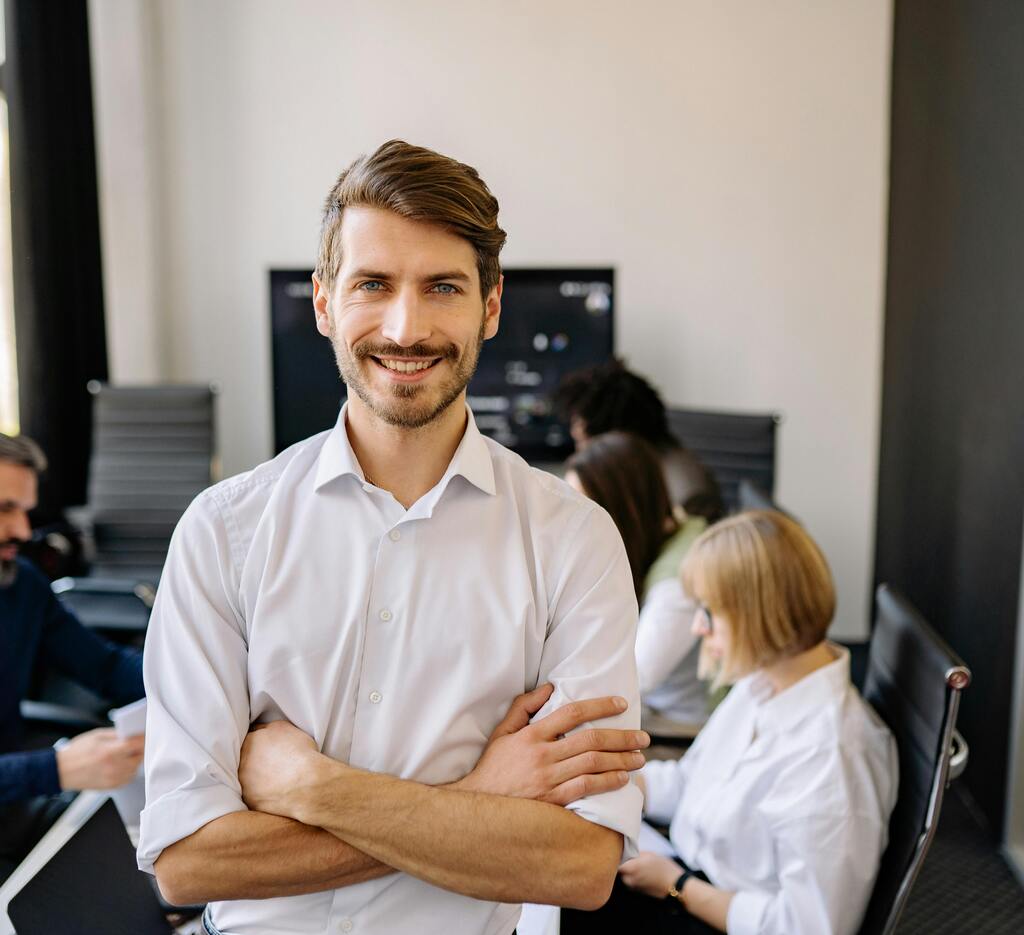 Male office worker smiling at desk