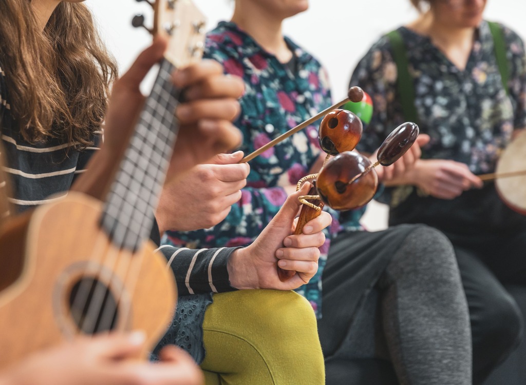 teens playing musical instruments in a class together