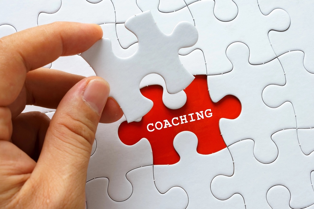 Ein Puzzle mit der Innenschrift Coaching