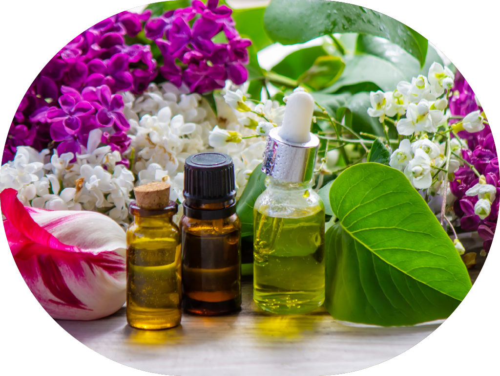 Bottles of essentials oils surrounded by bright flowers and botanticals