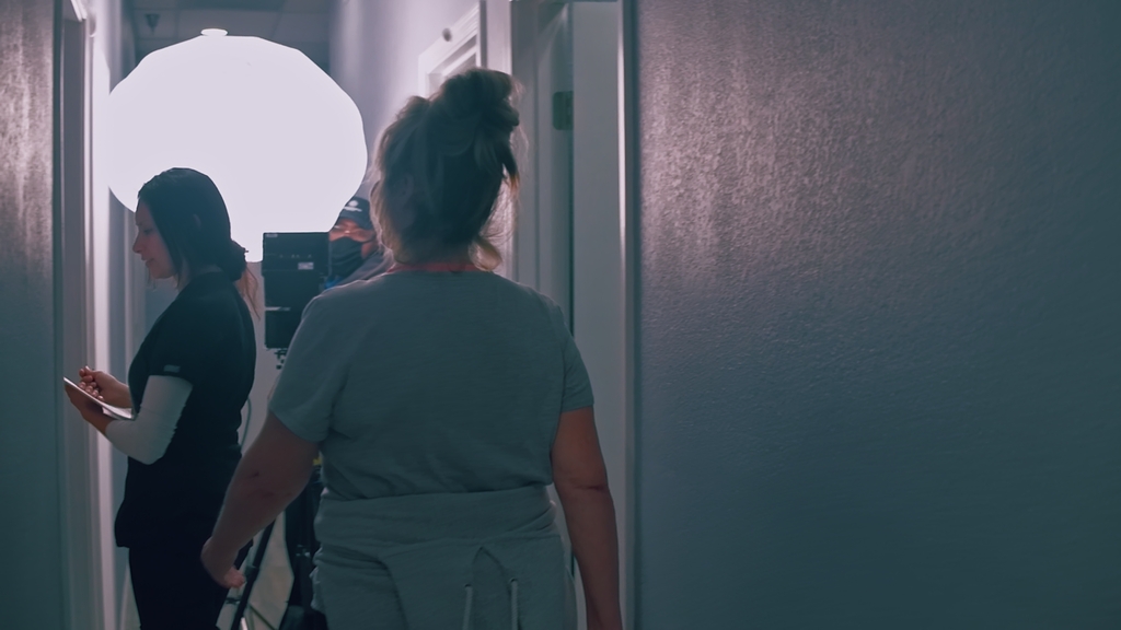 Cinematic Production image: “Filmmakers setting up professional cameras and lighting on location.”