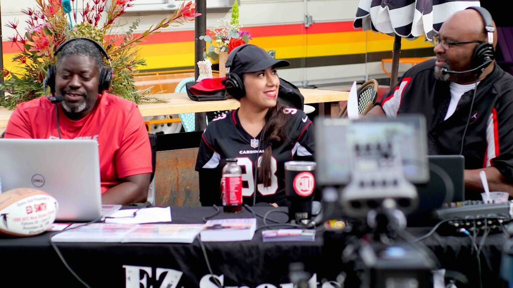 “Hosts reacting to sports highlights during live stream.”