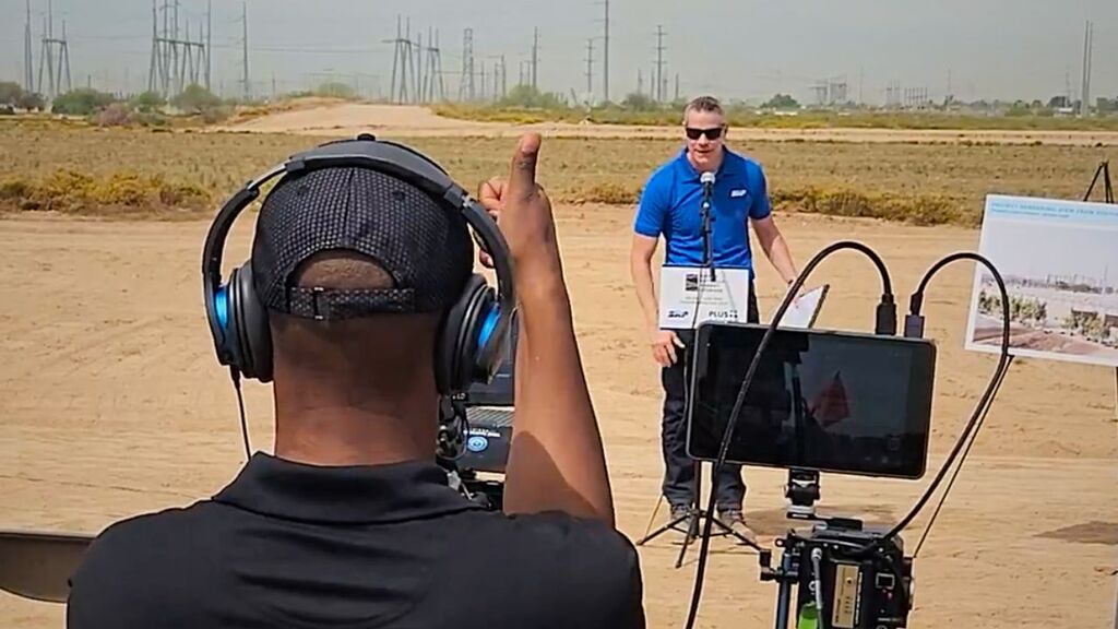 “Photographer directing a speaker during an outdoor brand shoot.”
