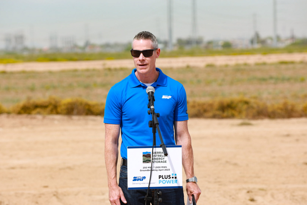 “Guest speaker addressing audience during corporate brand event.”