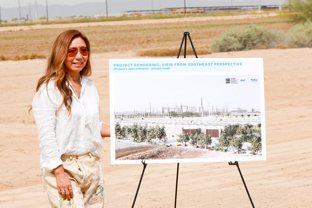 “Client showing project design rendering at event.”