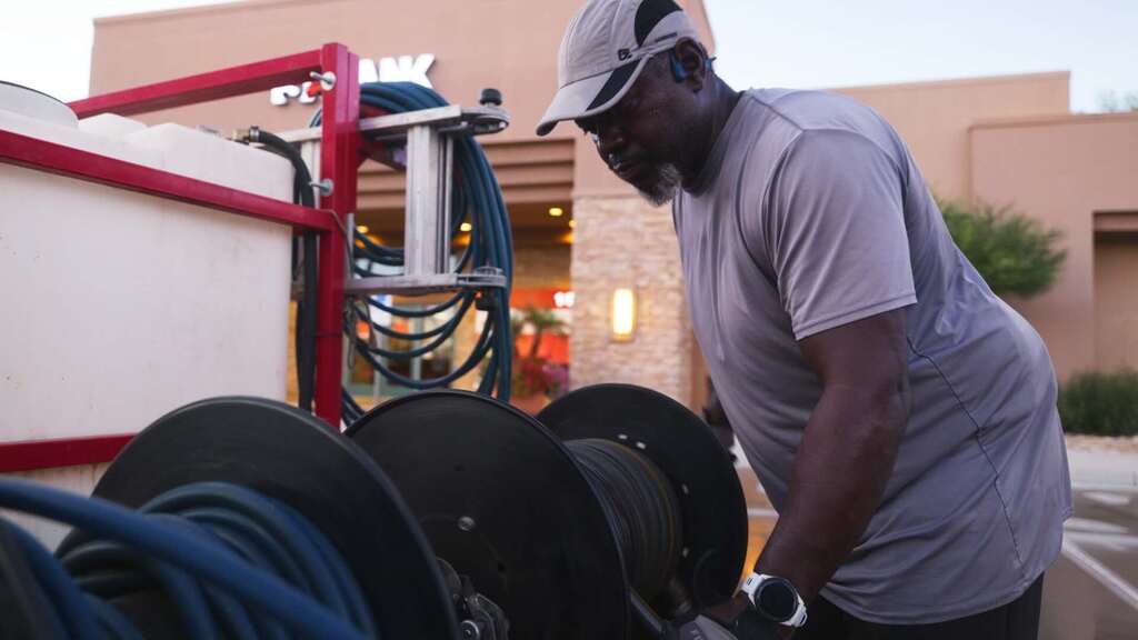 “Majestic Services team power‑washing prep at commercial property.”