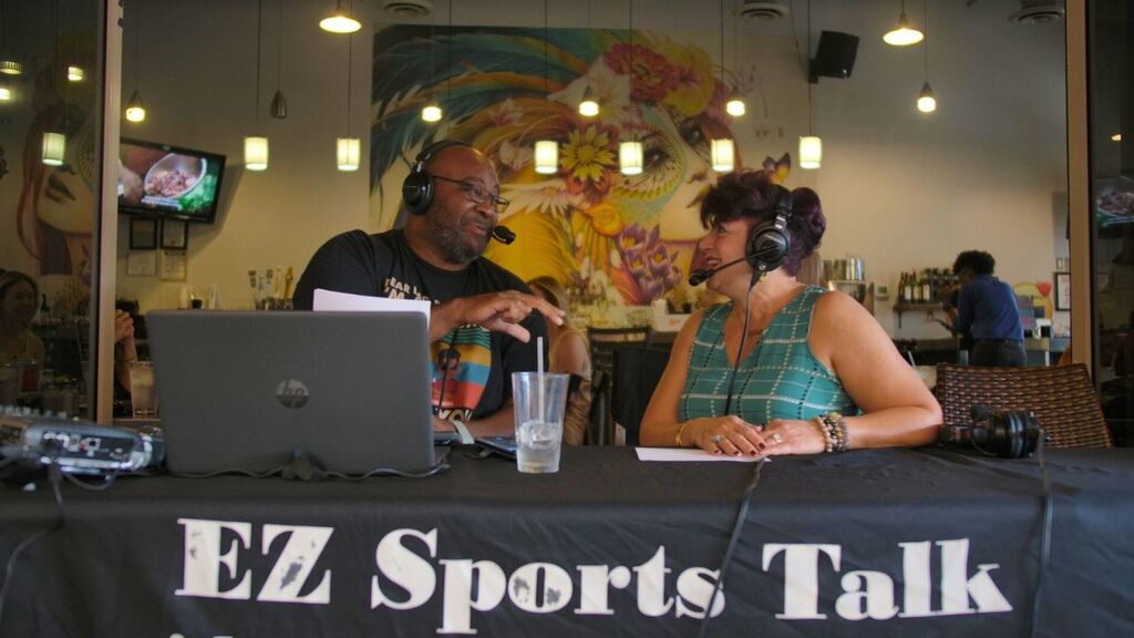 “Hosts reacting to guest during filming.”