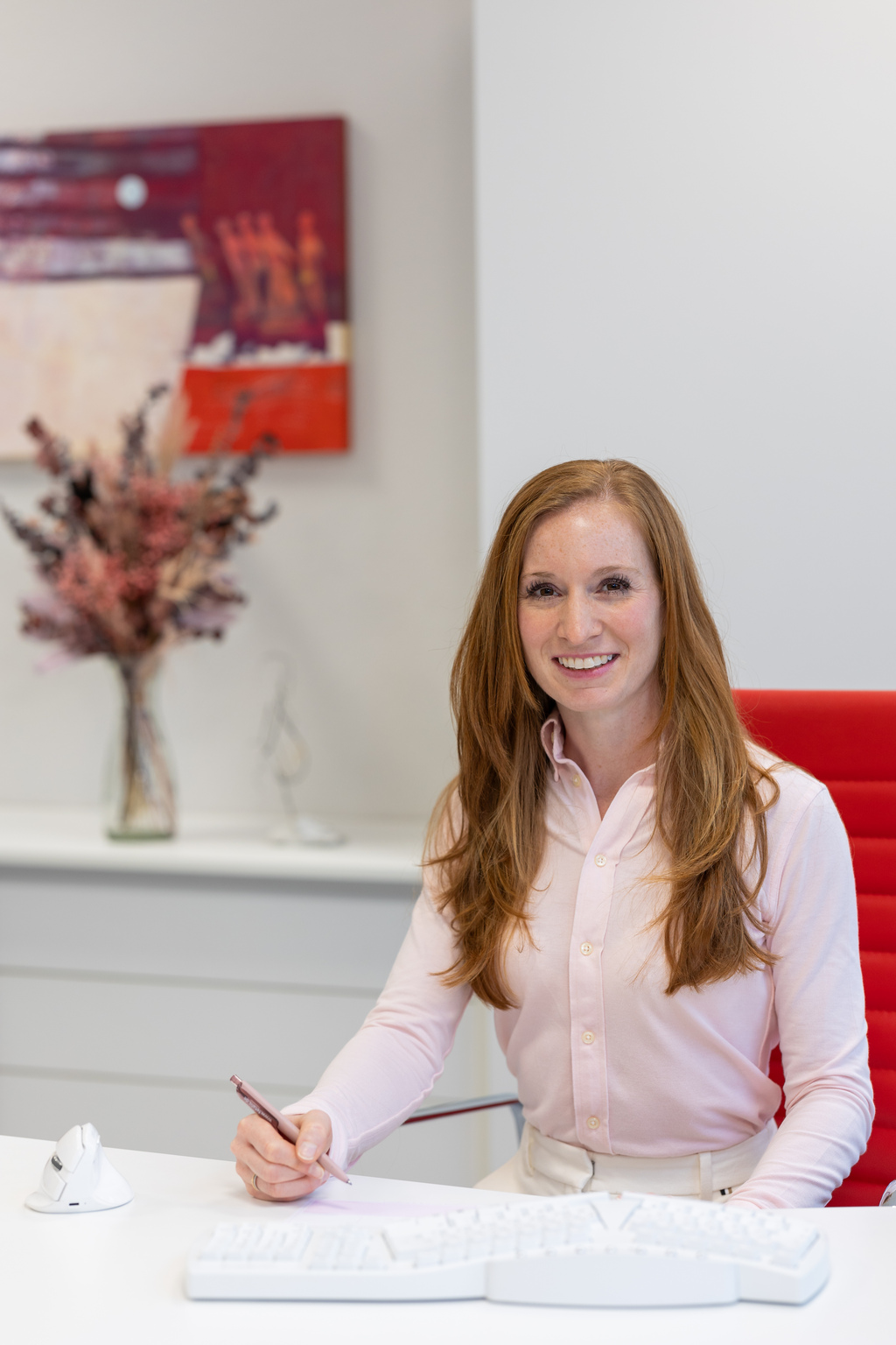 Jennifer Juhl am Schreibtisch lächelt in die Kamera