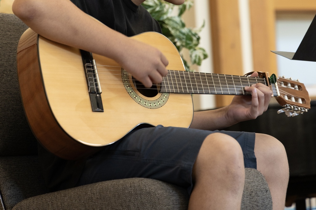 teens playing musical instruments in a class together