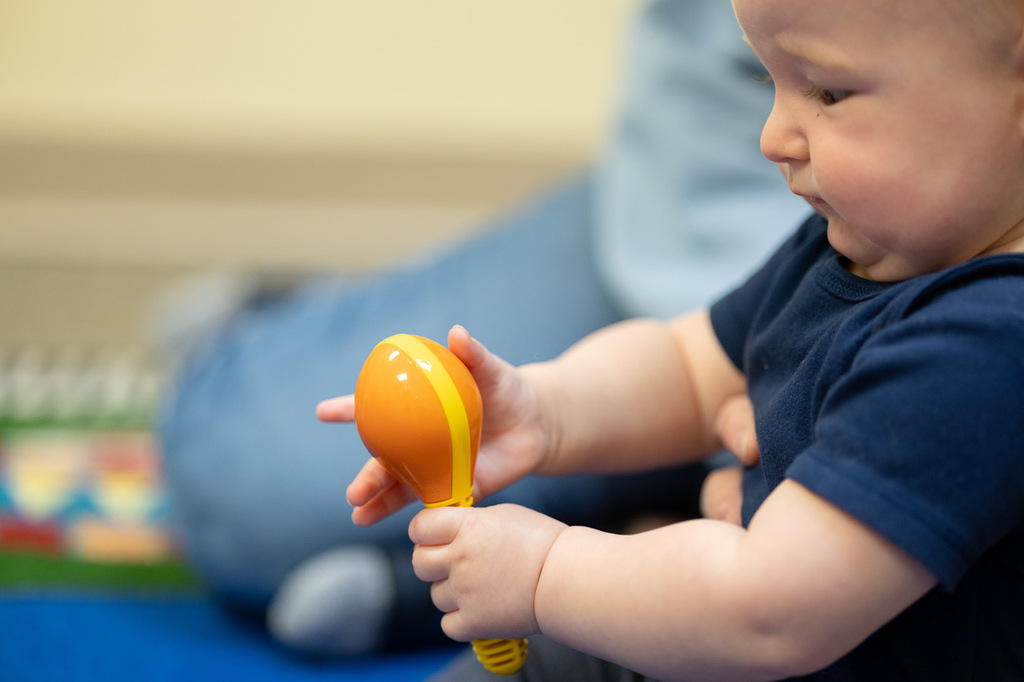 Little girl playing a toy piano in a music class