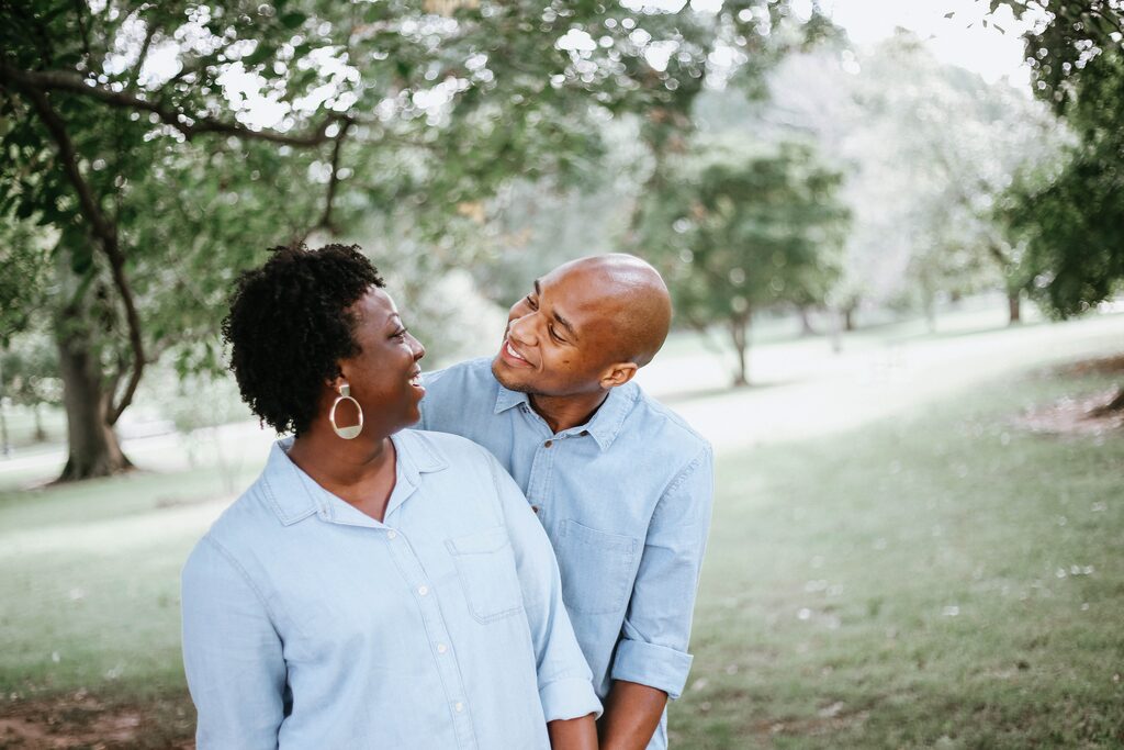 Couple laughing and embracing in a park