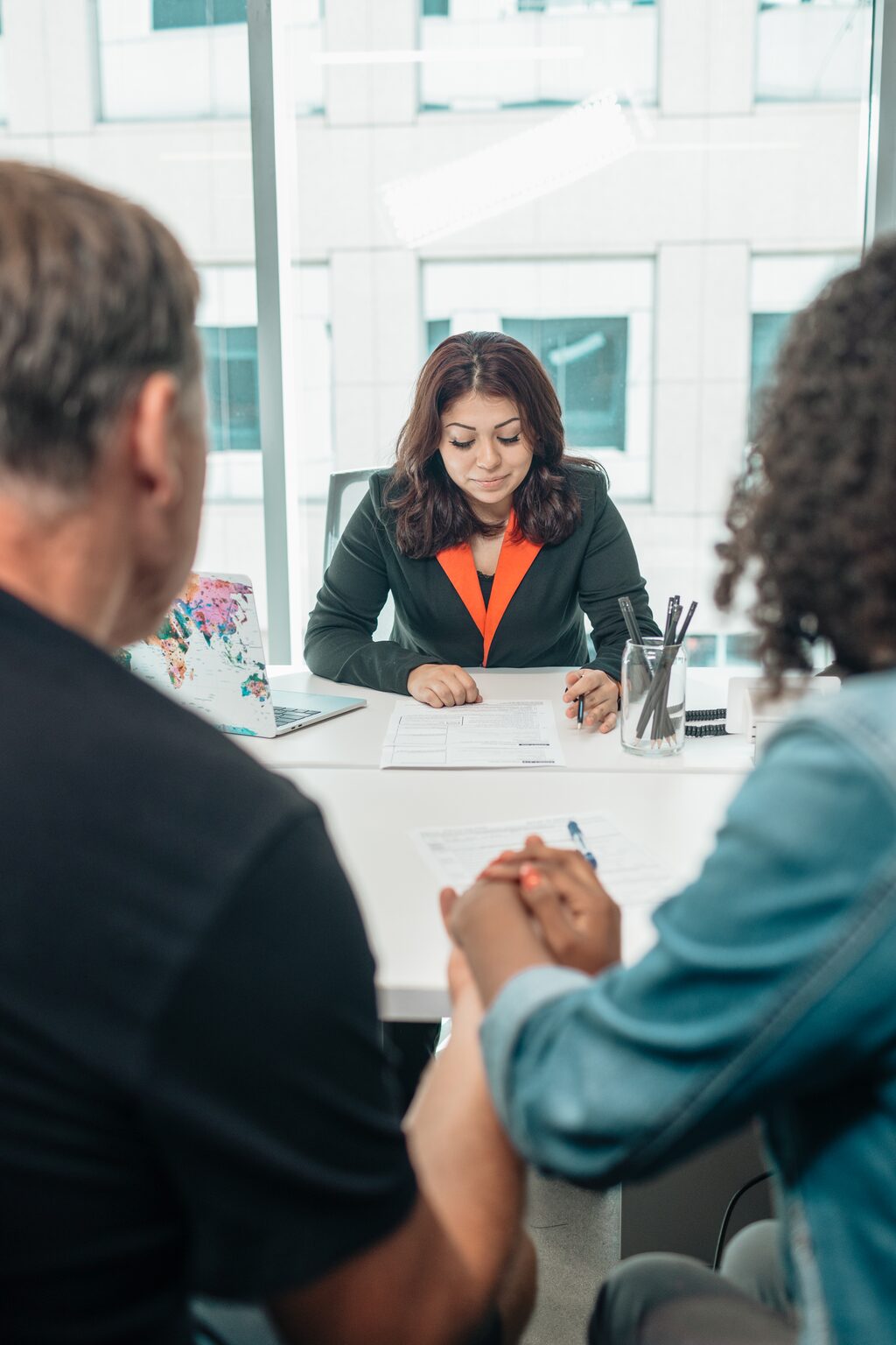 Brunette lady reviewing documents with older couple