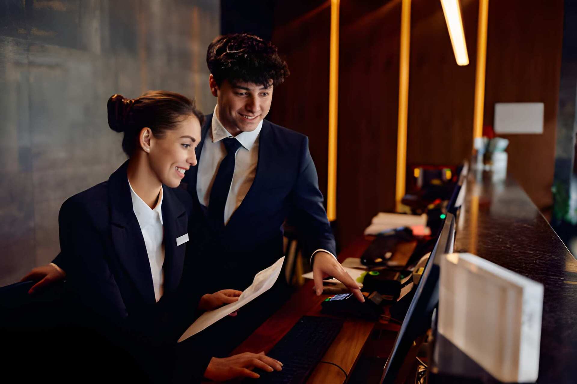 Hospitality professionals at a reception desk