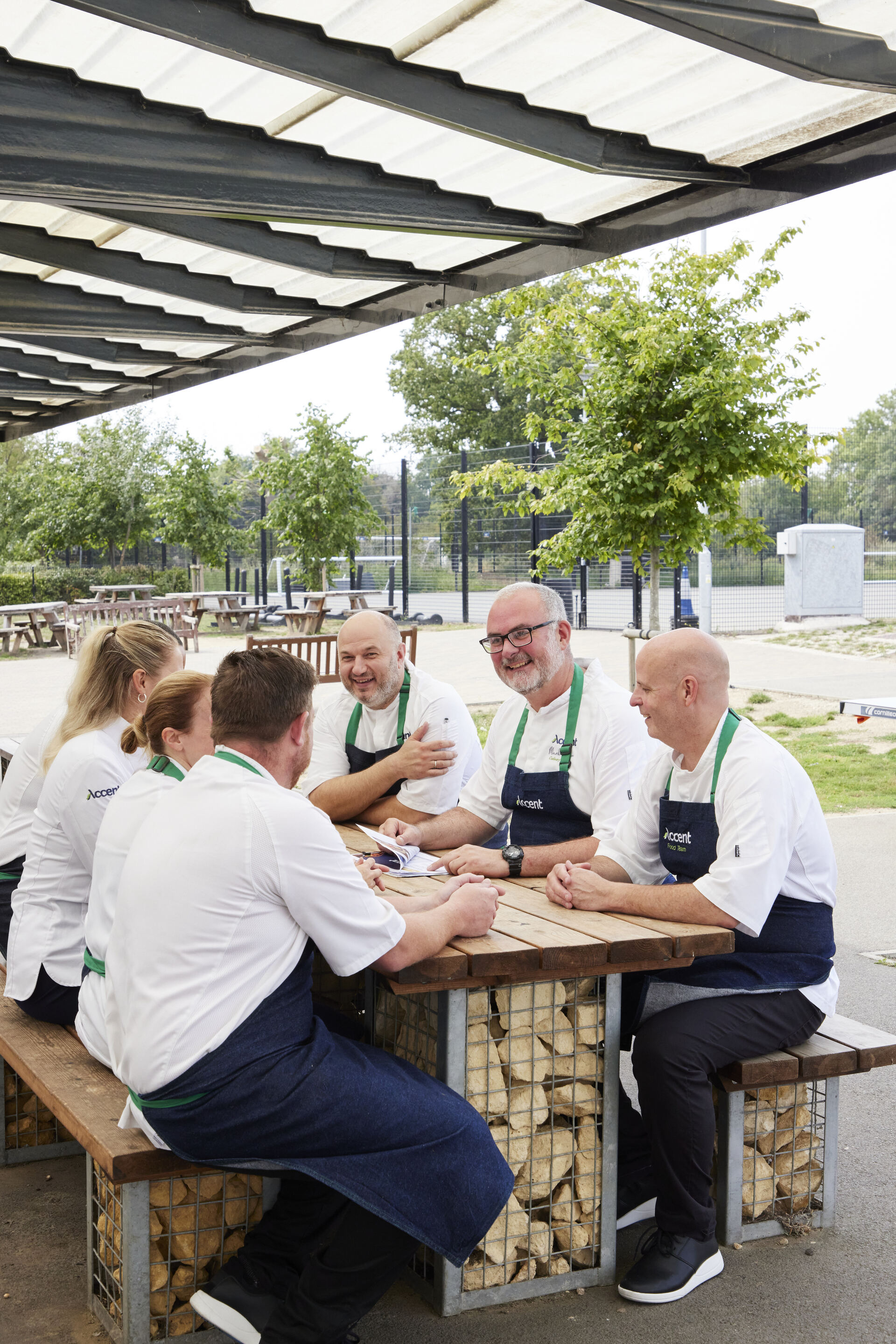 A group of people in a kitchen.