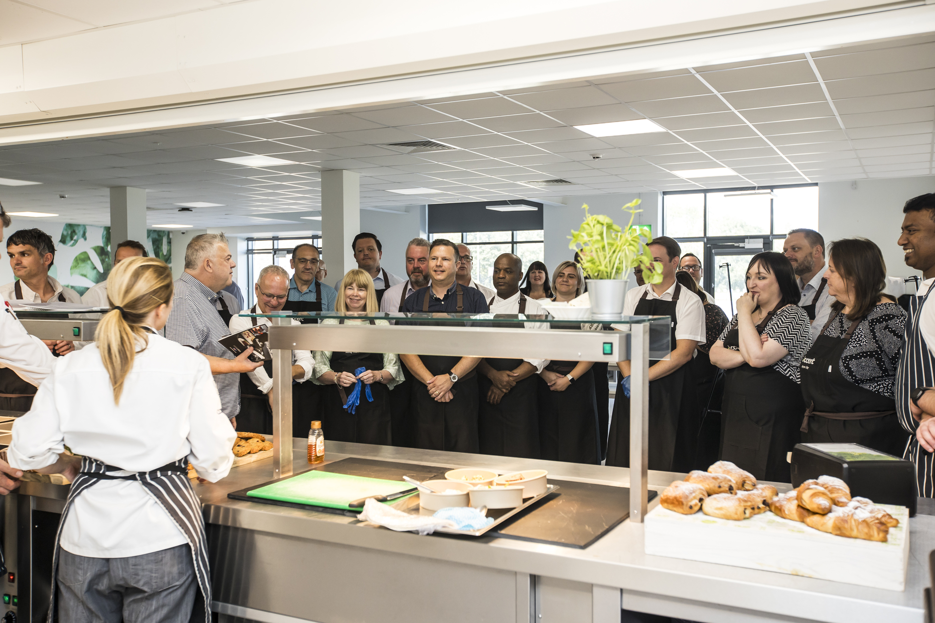 A group of people in a kitchen.