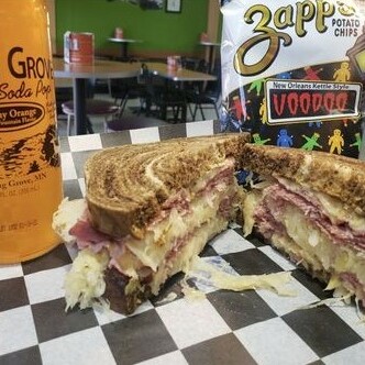 A Reuben sandwich, always served with chips and pictured with a Creamy Orange Spring Grove Soda. Click this image to see all of our Handheld meals. 