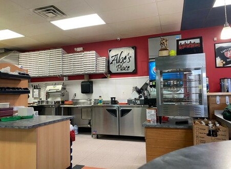 Abe's Place interior image showing pizza boxes and the drink machine.