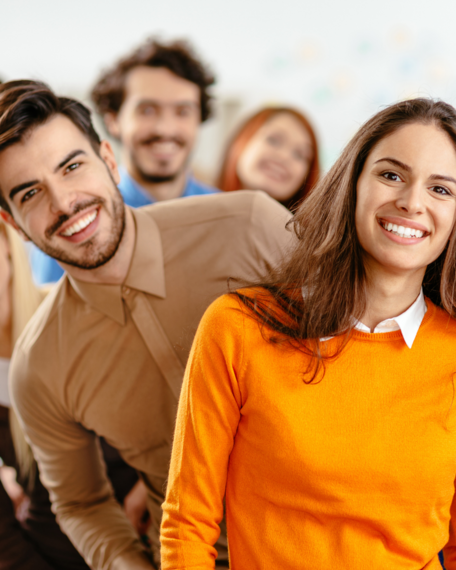 Group of happy colleagues smile at the camera