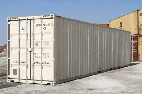 A white 40 HC shipping container sitting in a parking lot.