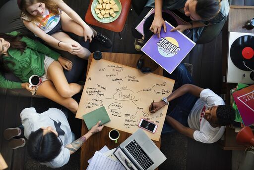 Co-workers around a table sharing ideas and brainstorming project ideas