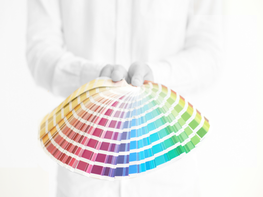 Close up of a person holding a spread of color swatches
