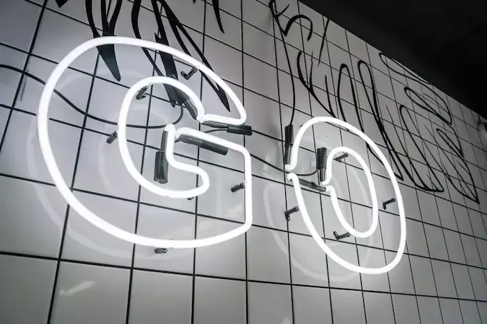 A neon lit sign that says GO