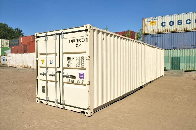 A white 40 DV shipping container sitting in a parking lot.