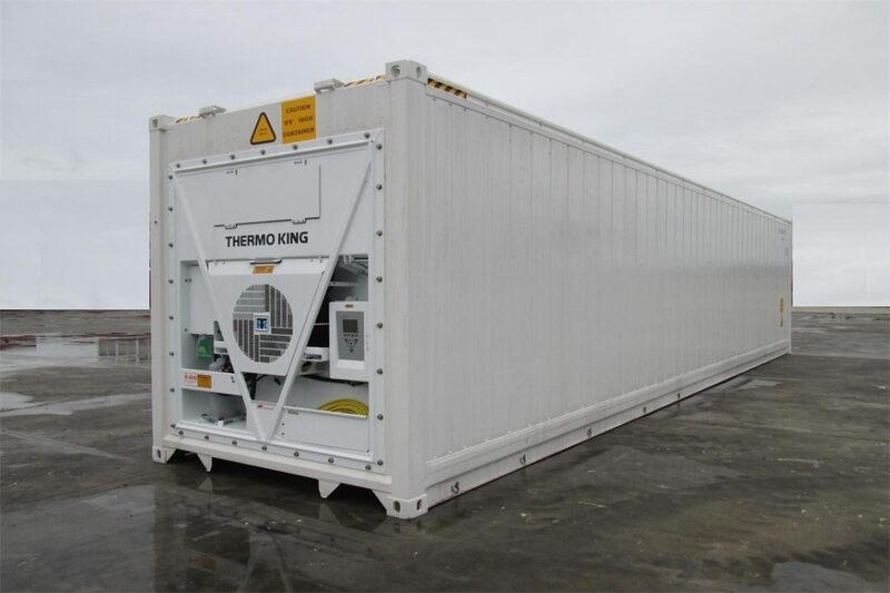 A white 40 HC reefer container shipping container with a refrigerator sitting in a parking lot.