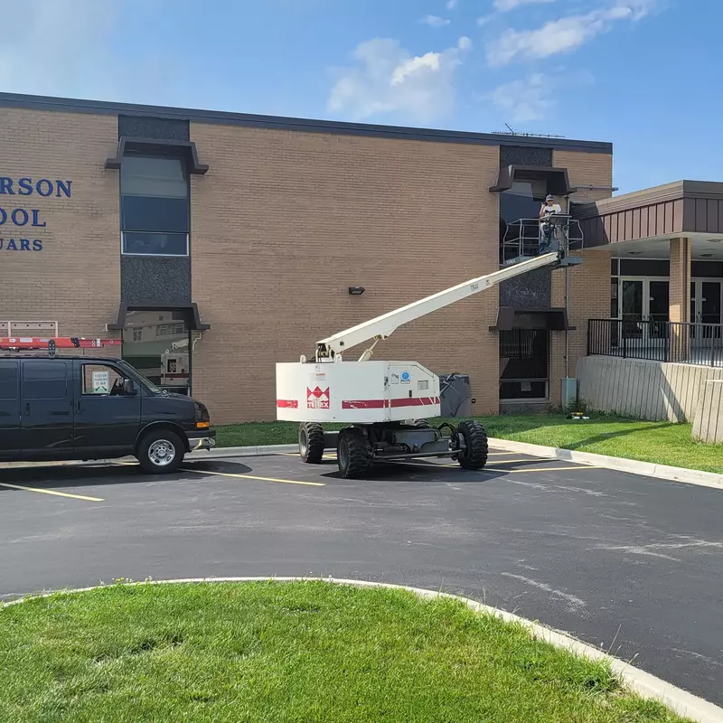 Repairing a window at Thomas Jefferson Middle School.